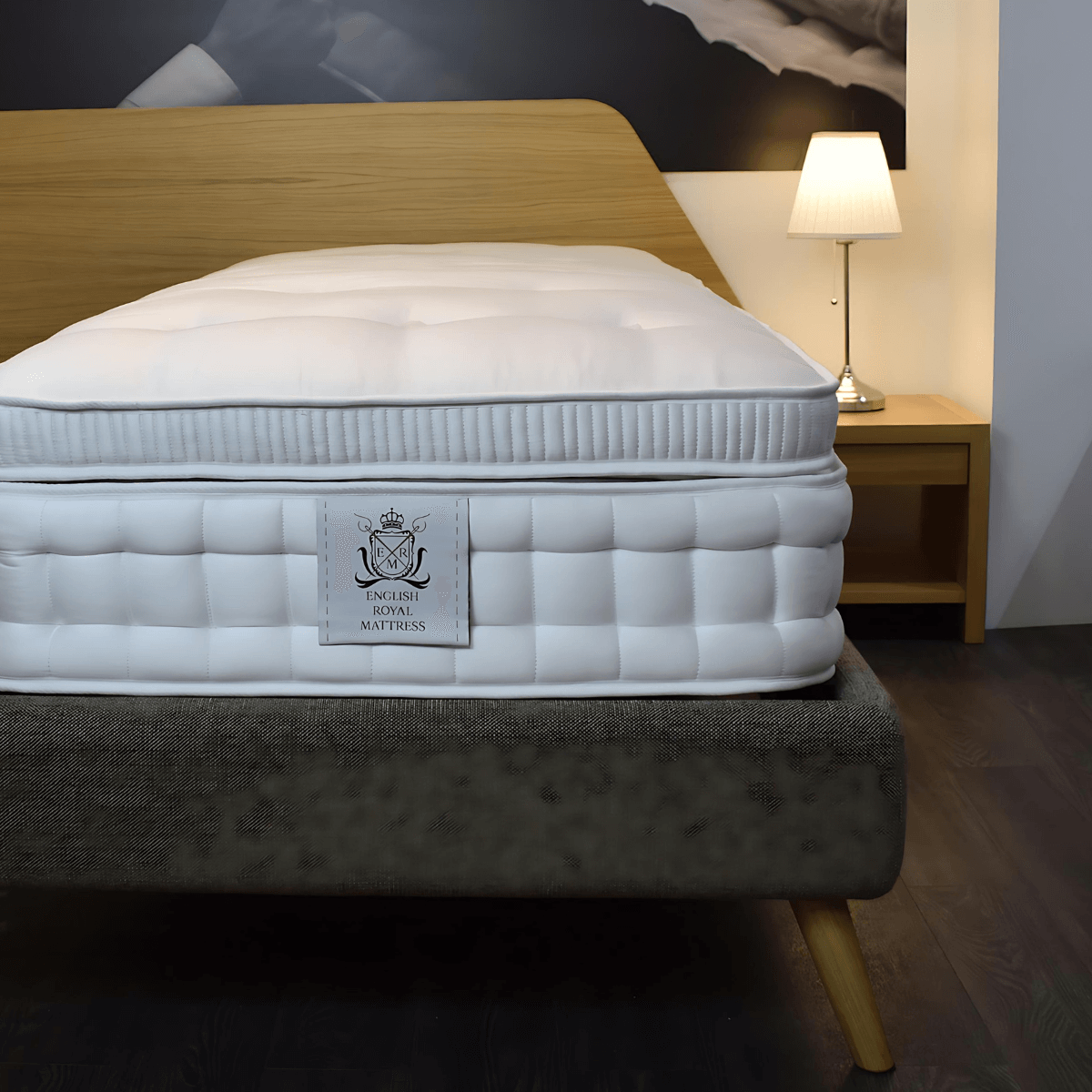 English Royal Mattress with top pillow on a bed frame in a modern bedroom setting